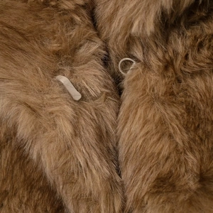 Short brown faux fur jacket featuring a wide lapel and secure hook-and-eye closure detail