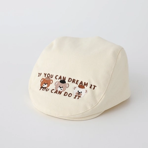 Close-up of three bears embroidery and motivational text on a beige cotton beret cap