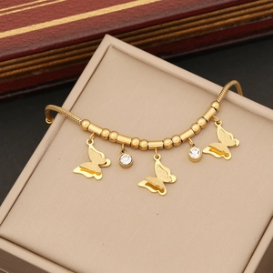 Close-up of golden butterfly beaded bracelet with cubic zirconia on a jewelry box