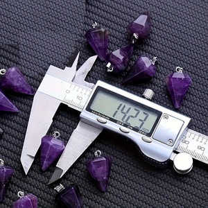 Natural hexagonal purple amethyst pendant being measured with a digital caliper for size