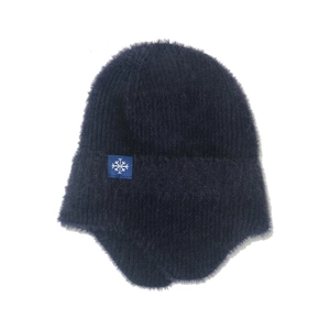 Detailed view of dark blue plush knit hat featuring soft fur texture and snowflake patch