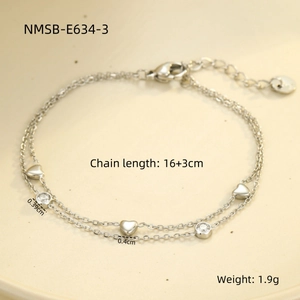 Detailed close-up of double-layer stainless steel heart bracelet with cubic zirconia charms