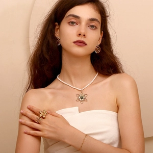 18K gold plated flower necklace with pearl and matching jewelry set on a model