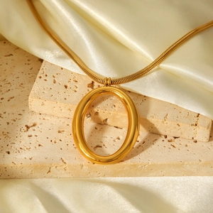 Elegant gold snake chain necklace with hollow oval pendant on stone and silk