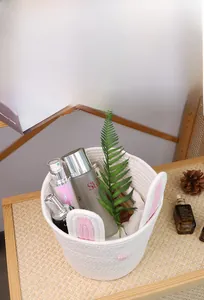 Detail of white cotton rope Easter rabbit basket used as a skincare product organizer