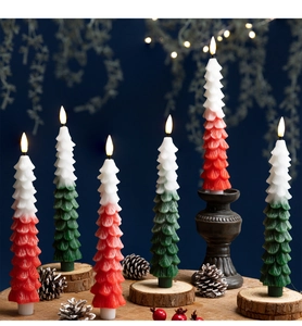 Detail of Christmas tree shaped LED candles with red and green gradient wax texture