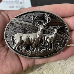Detailed close-up of oval vintage silver belt buckle with embossed deer and flag design