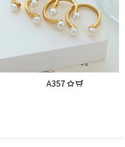 Detailed close-up of a three-piece gold-plated open ring set with elegant faux pearls