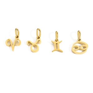 Macro shot of gold-plated stainless steel zodiac charms for Aries Taurus Gemini and Cancer