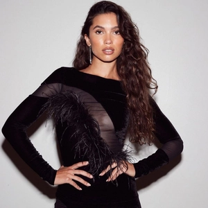 Elegant black velvet mini dress with sheer mesh panel and delicate feather fringe trim
