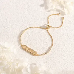 Close-up of golden AMOUR letter bracelet with zircon inlays and adjustable chain links