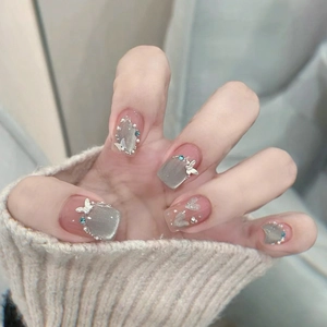 French gray cat eye press-on nails with 3D metal butterfly and blue rhinestone accents