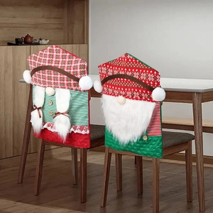 Christmas chair back covers with red and green gnome designs for holiday dining room decor