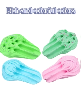 Flat lay of butter slime in green, blue, and pink with colorful sprinkles on white background