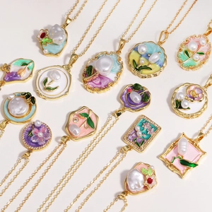 Flat lay of multiple oil painting style flower pendants with natural freshwater pearls