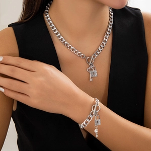 Detail view of silver Cuban chain set with pavé rhinestone lock and key pendants