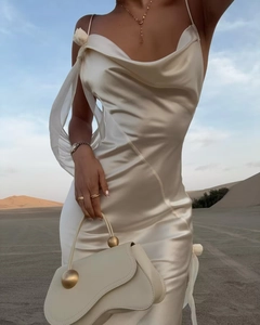 Close-up of white satin maxi dress with cowl neck and sheer tulle ribbon in desert