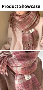 Detail of pink and brown plaid scarf with fringe and a rectangular woven brand tag