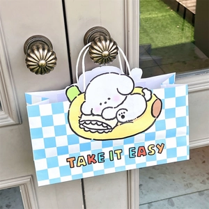 Cute cartoon puppy gift bag with blue checkered pattern hanging on a vintage door handle