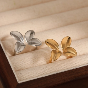 Minimalist adjustable leaf ring in gold and silver finish with polished metal texture
