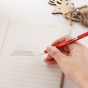 Close-up of 0.5mm Christmas reindeer gel pen writing smoothly on a lined notebook