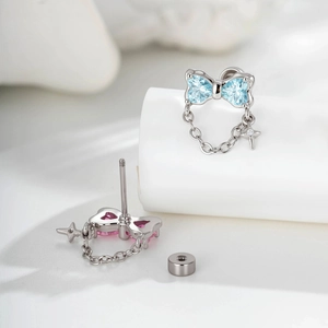 Elegant silver bow earrings with heart zircon, star chain tassels, and flat back studs