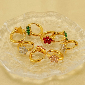 Gold stainless steel flower earrings set with colorful zircon crystals on a tray