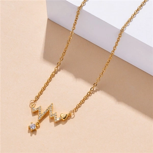 Golden heartbeat necklace with heart pendant and sparkling zircon on minimal display