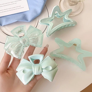 Set of 4 cream blue hair claws with bow and star designs for elegant hairstyling