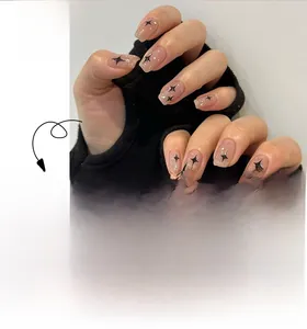 Star pattern short press-on nails in nude pink glitter finish with black cross stars