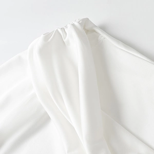 Close-up of white mesh fabric detailing with elegant ruched texture and fine stitching
