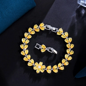 Detailed close-up of a floral bracelet with lemon yellow pear-cut cubic zirconia crystals