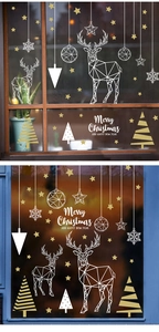 Detail of white and gold Christmas window stickers featuring reindeer and star designs