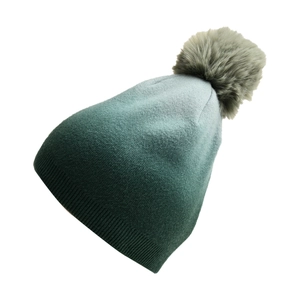Close-up of tie-dye gradient green knit beanie with a fluffy faux fur pompom detail