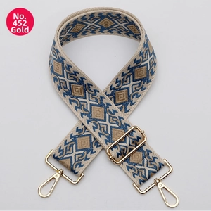 Close-up of geometric diamond pattern strap with golden metal swivel hooks and slider