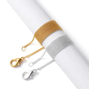 Detailed view of gold and silver DIY jewelry chains with lobster clasps and o-links
