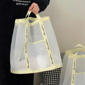 Minimalist creamy white mesh storage bag with reinforced handles for bathroom organization
