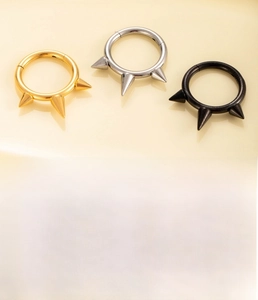 Detailed view of G23 titanium cone earrings in silver, gold and black finishes