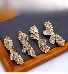 Detail of four-piece gold alloy hair clips set with pearls and rhinestones