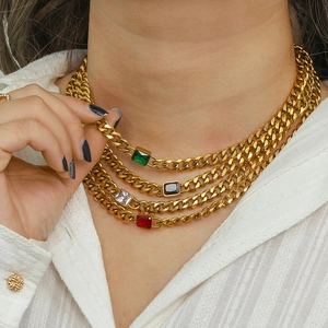 Detailed view of layered 18K gold plated Cuban chains with colorful zircon pendants