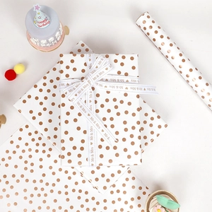 Metallic rose gold polka dot gift wrapping paper with Mr & Mrs ribbon for weddings and birthdays