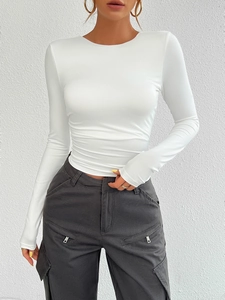 Close-up of white slim fit long sleeve knit top with a classic round neckline