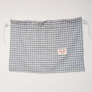 Blue and white plaid car sunshade curtain with suction cups and a smiling face tag