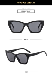 Detail view showing black thick-frame cat-eye sunglasses with dark grey lenses and C1 code