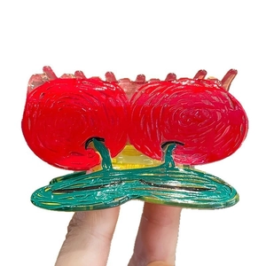 Hand-painted red cherry hair claw clip made of textured acrylic with spiral patterns