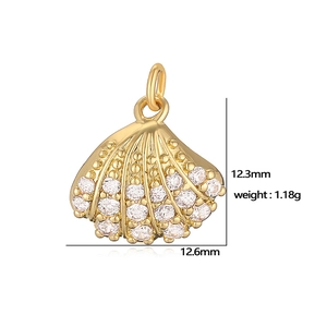 Detailed macro view of a gold scallop shell pendant with clear gems and dimensions