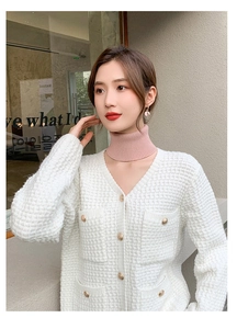 Close-up of a pink knitted turtleneck dickey collar styled with a white jacket for women
