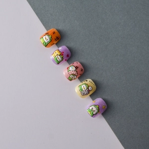 Detailed view of 5D cute dinosaur nail stickers with short round colorful cartoon designs