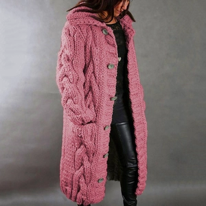Close-up of pink cable-knit cardigan showing thick wool texture and large buttons