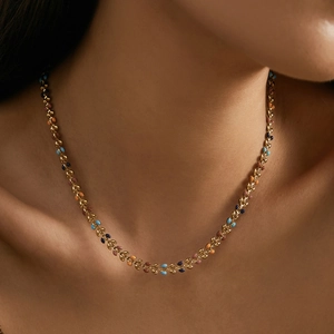Golden leaf necklace set with multi-colored enamel petals on an elegant link chain